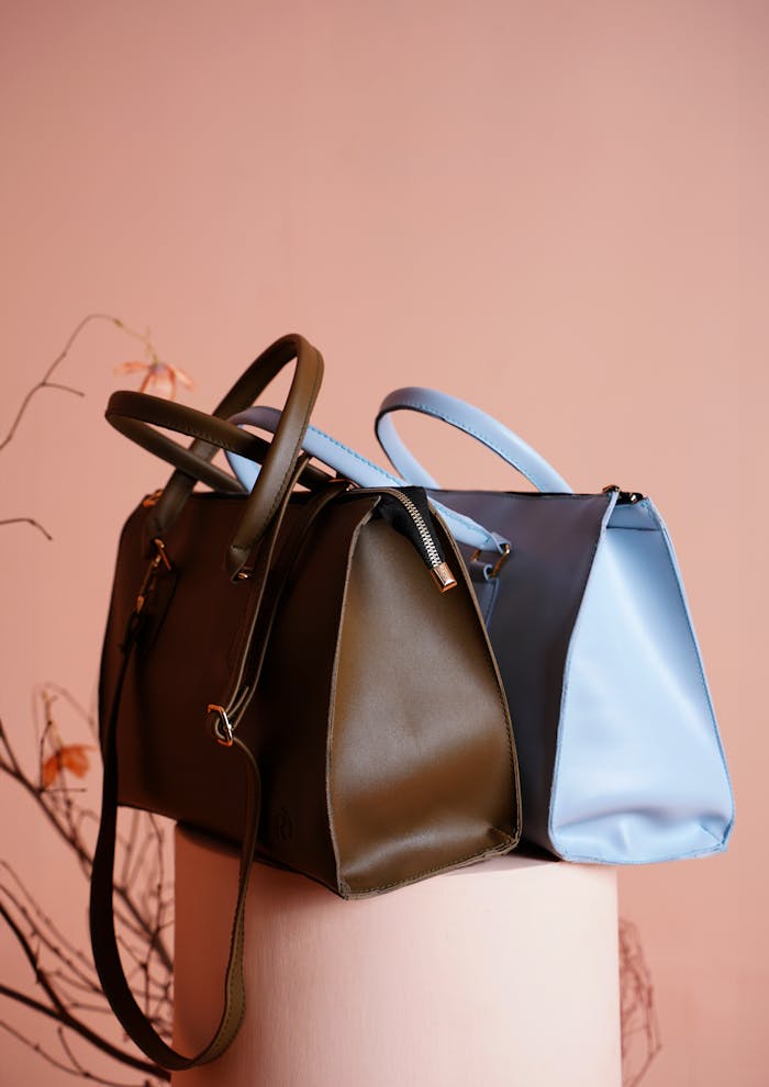 Chic designer handbags displayed in an elegant studio setup, highlighting modern fashion accessories.